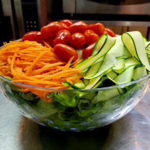 (Party bowl) Mixed greens salad with white wine vinaigrette, garden vegetables, & toasted sunflower-pumpkin brittle
